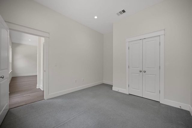 13501 Metric Blvd Unit 22, Austin, TX 78727 - unfurnished bedroom featuring baseboards, carpet floors, a closet, and recessed lighting