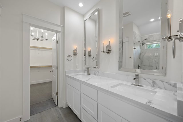 13501 Metric Blvd Unit 22, Austin, TX 78727 - full bath with a chandelier, a marble finish shower, double vanity, a walk in closet, and recessed lighting