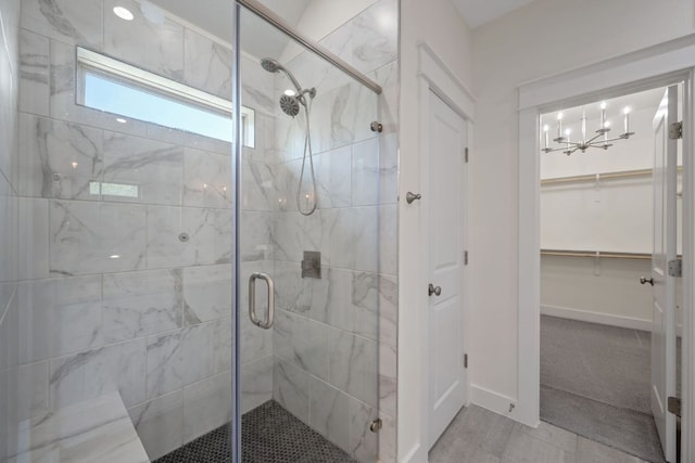 13501 Metric Blvd Unit 22, Austin, TX 78727 - full bath featuring a stall shower, a chandelier, a spacious closet, and baseboards