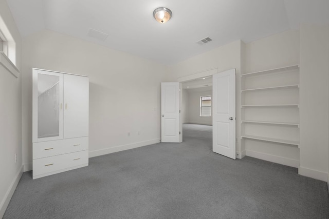13501 Metric Blvd Unit 22, Austin, TX 78727 - unfurnished bedroom with dark colored carpet and baseboards