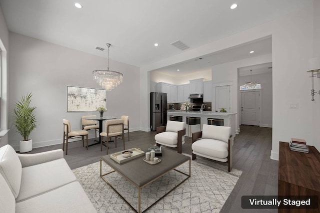 13501 Metric Blvd Unit 22, Austin, TX 78727 - living room featuring recessed lighting, wood finished floors, baseboards, and a chandelier