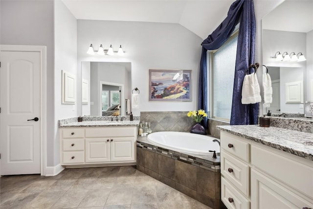 2628 Reunion Blvd, Austin, TX 78737 - bathroom with a garden tub, lofted ceiling, healthy amount of natural light, two vanities, and tile patterned flooring