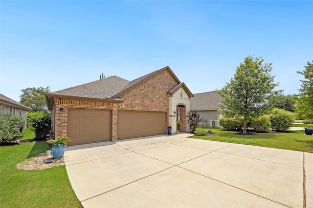 2628 Reunion Blvd, Austin, TX 78737 - view of front facade with brick siding, a garage, concrete driveway, a front lawn, and a shingled roof