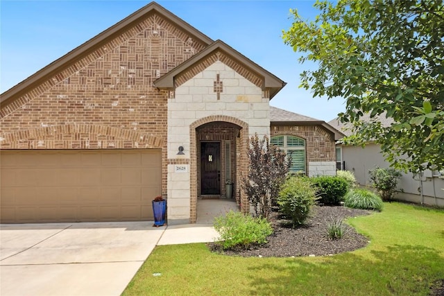 2628 Reunion Blvd, Austin, TX 78737 - french country home featuring brick siding, a front lawn, a garage, and driveway