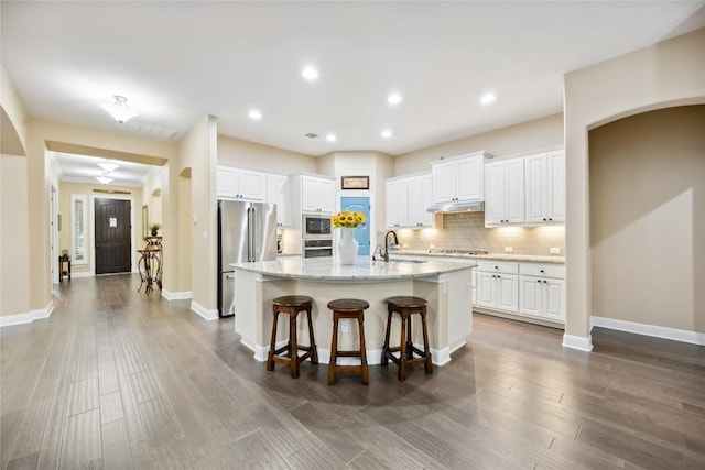 2628 Reunion Blvd, Austin, TX 78737 - kitchen with appliances with stainless steel finishes, under cabinet range hood, white cabinetry, a sink, and recessed lighting
