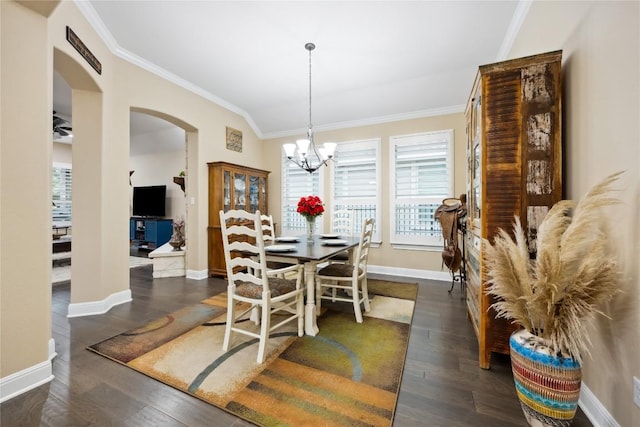 2628 Reunion Blvd, Austin, TX 78737 - dining space with arched walkways, ornamental molding, dark wood finished floors, baseboards, and a chandelier
