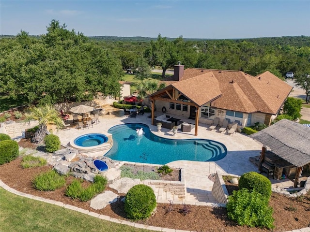 1020 Foothills Dr, Dripping Springs, TX 78620 - outdoor pool featuring an in-ground hot tub, a patio area, a view of trees, a gazebo, and outdoor dining space