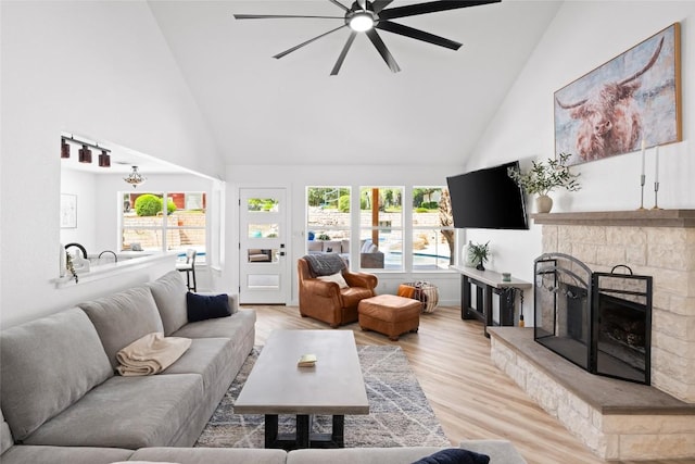 1020 Foothills Dr, Dripping Springs, TX 78620 - living area featuring high vaulted ceiling, a ceiling fan, light wood-style floors, plenty of natural light, and a stone fireplace