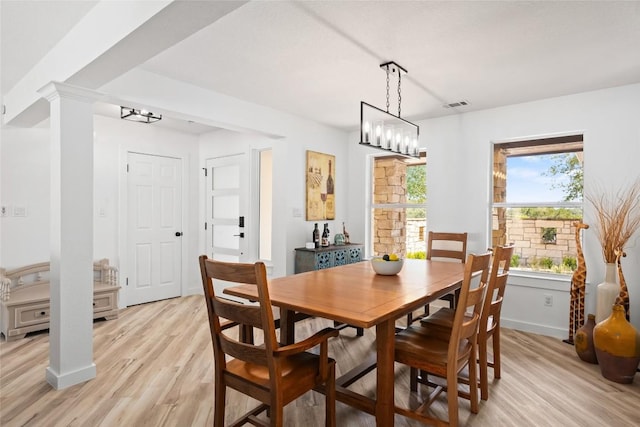 1020 Foothills Dr, Dripping Springs, TX 78620 - dining space with light wood-style floors, a chandelier, and ornate columns