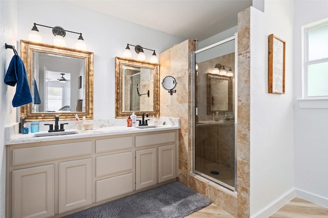 1020 Foothills Dr, Dripping Springs, TX 78620 - full bath with a stall shower, double vanity, and wood finished floors