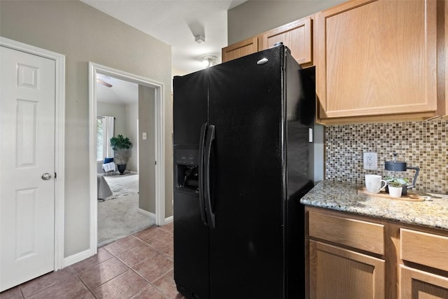 1301 S Quinlan Park Rd, Austin, TX 78732 - kitchen featuring black refrigerator with ice dispenser, light brown cabinetry, backsplash, and tile patterned floors