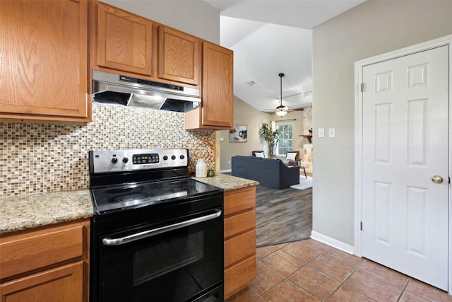 1301 S Quinlan Park Rd, Austin, TX 78732 - kitchen with under cabinet range hood, black electric range oven, decorative backsplash, and light tile patterned floors