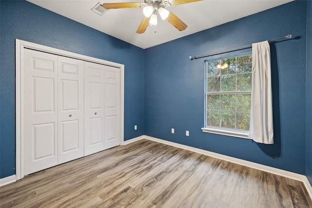 1301 S Quinlan Park Rd, Austin, TX 78732 - unfurnished bedroom featuring wood finished floors, baseboards, a closet, and ceiling fan
