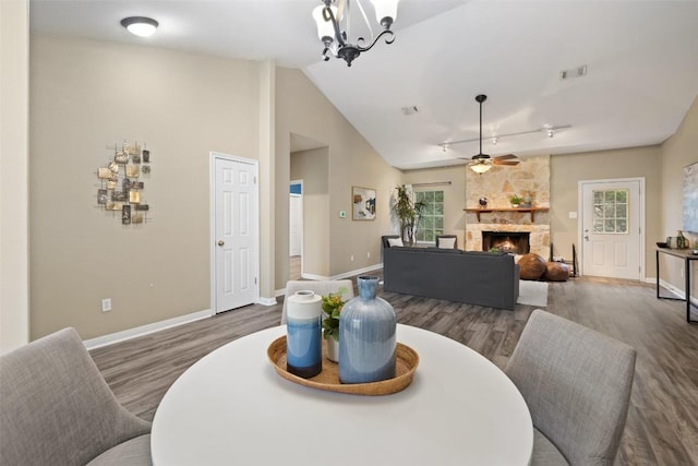 1301 S Quinlan Park Rd, Austin, TX 78732 - dining space with wood finished floors, plenty of natural light, a fireplace, and lofted ceiling