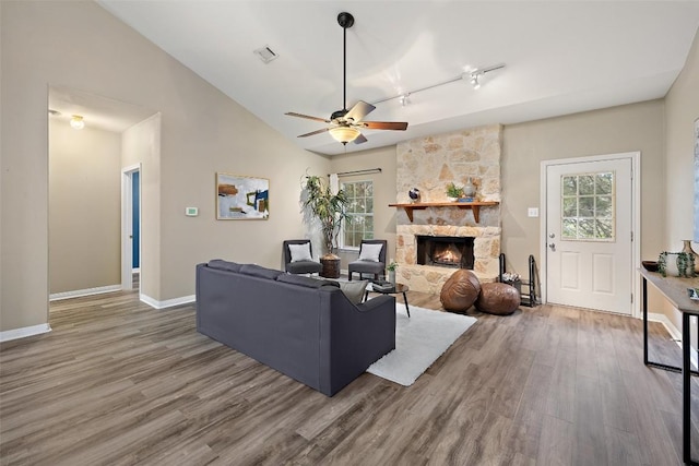 1301 S Quinlan Park Rd, Austin, TX 78732 - living room with wood finished floors, a ceiling fan, baseboards, and a fireplace