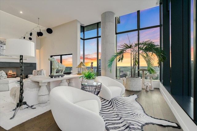 210 Lavaca St Unit 3603, Austin, TX 78701 - living area with wood finished floors, a warm lit fireplace, and expansive windows
