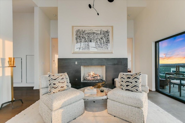 210 Lavaca St Unit 3603, Austin, TX 78701 - living area with wood finished floors, a high ceiling, and a warm lit fireplace