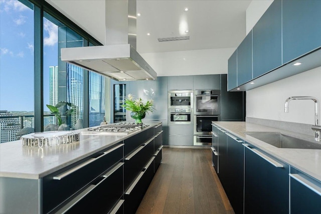 210 Lavaca St Unit 3603, Austin, TX 78701 - kitchen with a sink, island range hood, stainless steel appliances, dark wood-style flooring, and modern cabinets