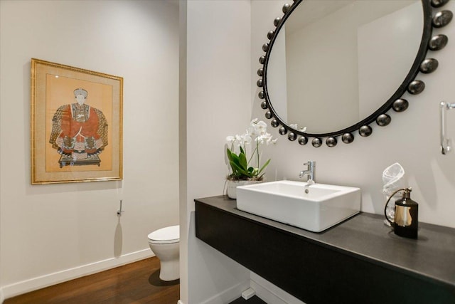 210 Lavaca St Unit 3603, Austin, TX 78701 - bathroom with toilet, baseboards, wood finished floors, and vanity