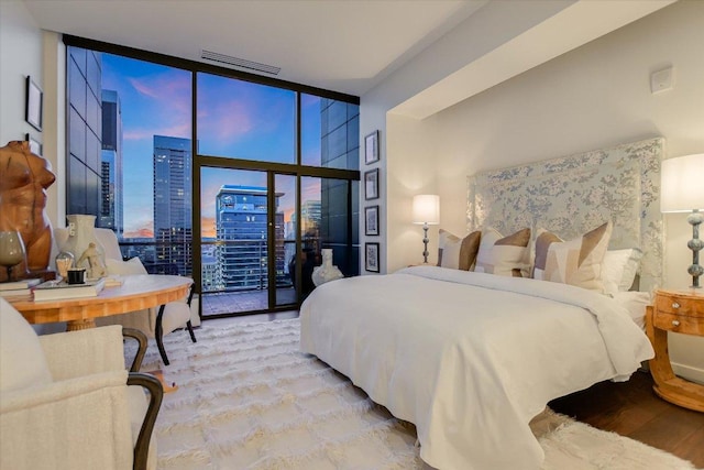 210 Lavaca St Unit 3603, Austin, TX 78701 - bedroom featuring expansive windows, access to outside, a view of city, and wood finished floors