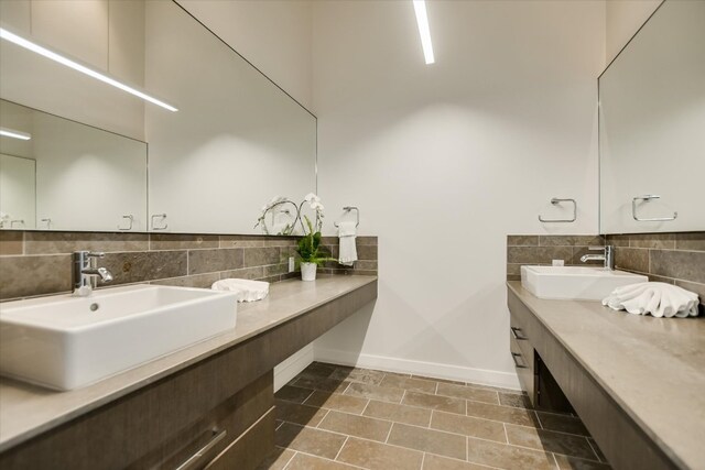 210 Lavaca St Unit 3603, Austin, TX 78701 - bathroom featuring baseboards, decorative backsplash, vanity, and tile patterned flooring