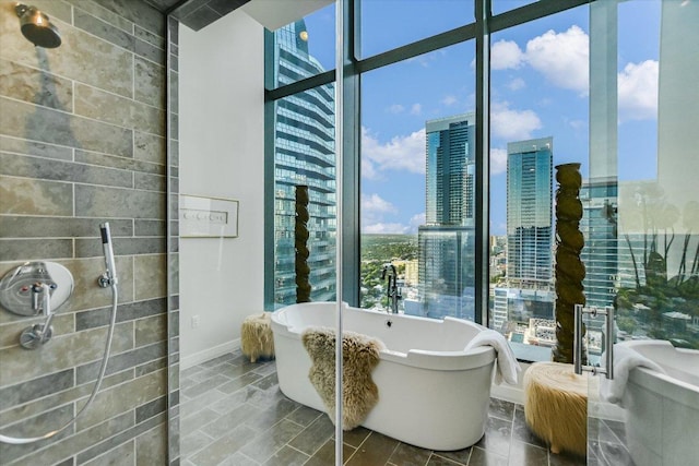 210 Lavaca St Unit 3603, Austin, TX 78701 - bathroom featuring a city view, a soaking tub, and baseboards