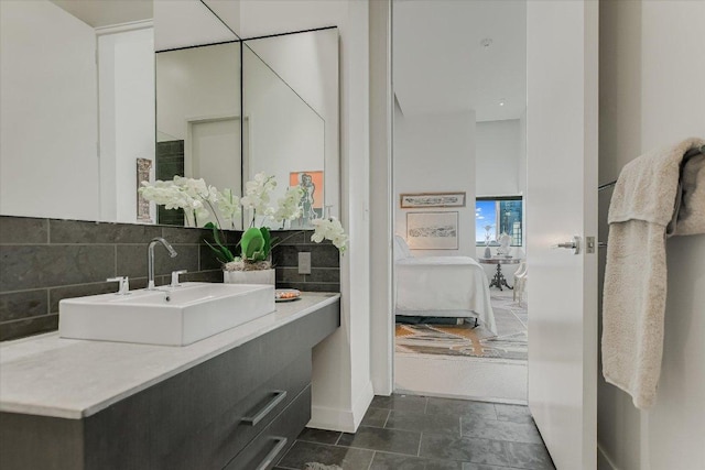 210 Lavaca St Unit 3603, Austin, TX 78701 - bathroom with vanity, connected bathroom, and tasteful backsplash