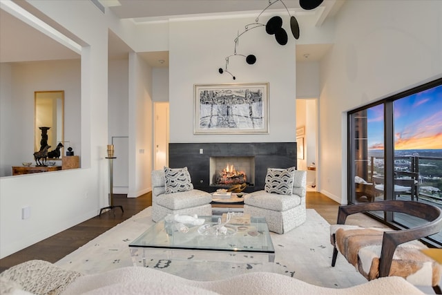 210 Lavaca St Unit 3603, Austin, TX 78701 - living area featuring wood finished floors, a warm lit fireplace, baseboards, and a high ceiling