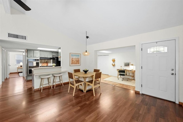 4610 S 1st St, Austin, TX 78745 - dining room with dark wood-style flooring, vaulted ceiling, and an office area