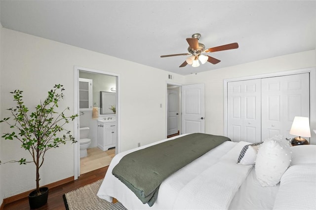 4610 S 1st St, Austin, TX 78745 - bedroom featuring wood finished floors, a closet, ensuite bathroom, and a ceiling fan