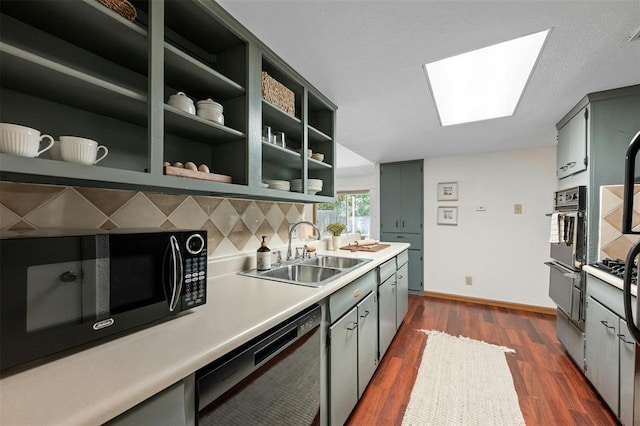 4610 S 1st St, Austin, TX 78745 - kitchen featuring dishwasher, black microwave, a skylight, dark wood-style floors, and light countertops