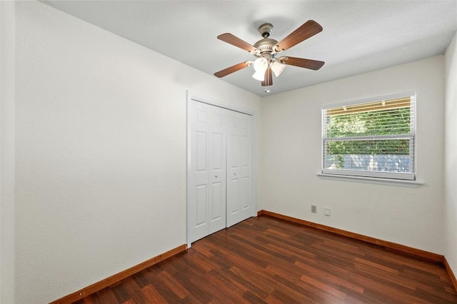 4610 S 1st St, Austin, TX 78745 - unfurnished bedroom with dark wood-type flooring, a closet, and ceiling fan