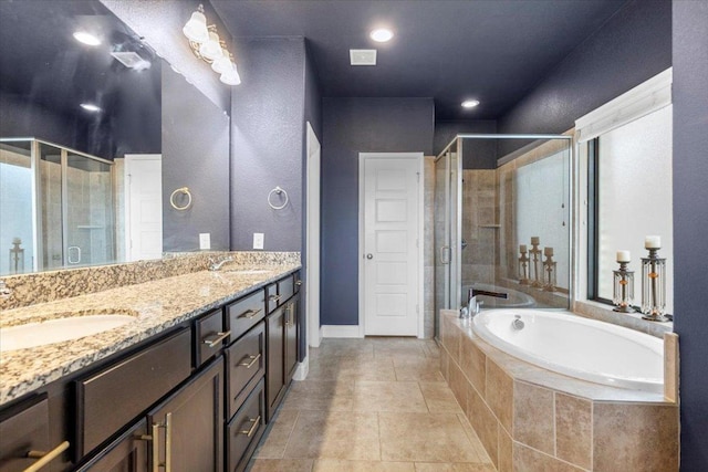 6500 Llano Stage Trl, Austin, TX 78738 - bathroom featuring a bath, double vanity, a stall shower, baseboards, and tile patterned flooring