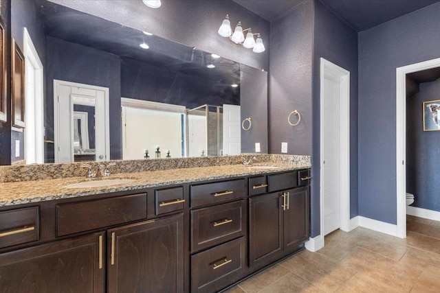 6500 Llano Stage Trl, Austin, TX 78738 - bathroom featuring double vanity, toilet, tile patterned flooring, and baseboards