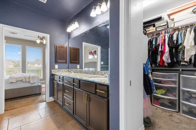 6500 Llano Stage Trl, Austin, TX 78738 - full bath with double vanity, tile patterned flooring, and a walk in closet