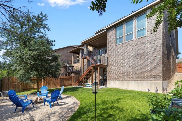 6500 Llano Stage Trl, Austin, TX 78738 - back of property with brick siding, stairway, a fire pit, and a patio area
