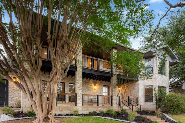 7302 Jester Blvd, Austin, TX 78750 - view of front of home with a balcony, stone siding, and covered porch