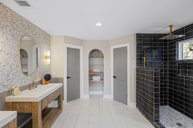 7302 Jester Blvd, Austin, TX 78750 - bathroom with tiled shower, tile patterned flooring, recessed lighting, vanity, and baseboards