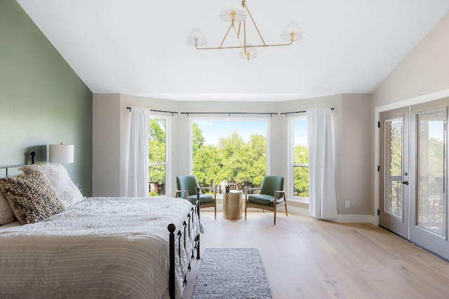 7302 Jester Blvd, Austin, TX 78750 - bedroom with a chandelier, wood finished floors, multiple windows, baseboards, and lofted ceiling