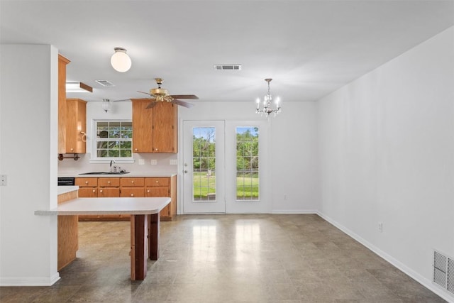 8281 Mountain Dr, Salado, TX 76571 - kitchen featuring light countertops, baseboards, a ceiling fan, brown cabinetry, and a sink