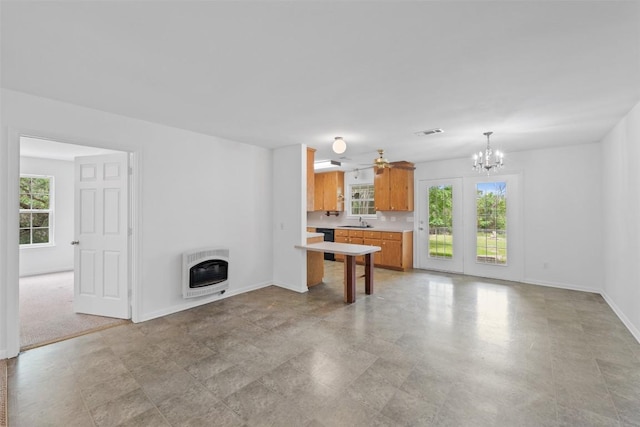 8281 Mountain Dr, Salado, TX 76571 - unfurnished living room with heating unit, a sink, healthy amount of natural light, and a chandelier