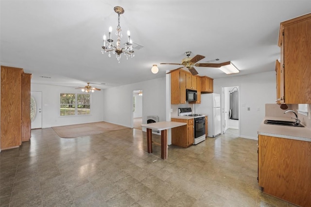 8281 Mountain Dr, Salado, TX 76571 - kitchen featuring gas stove, black microwave, a sink, and a ceiling fan
