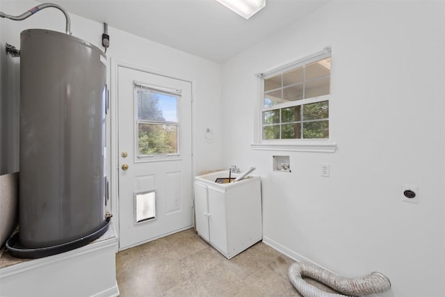 8281 Mountain Dr, Salado, TX 76571 - washroom with electric water heater, electric dryer hookup, healthy amount of natural light, and baseboards