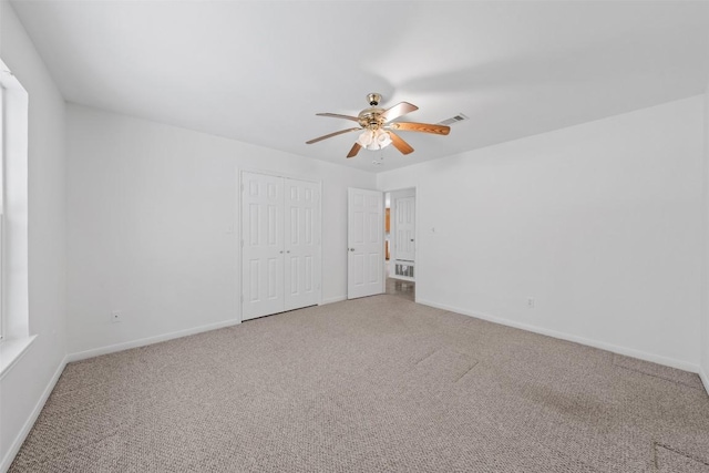8281 Mountain Dr, Salado, TX 76571 - unfurnished bedroom featuring carpet, baseboards, a closet, and a ceiling fan