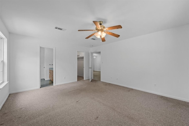 8281 Mountain Dr, Salado, TX 76571 - unfurnished bedroom featuring carpet floors, a walk in closet, baseboards, and ensuite bath