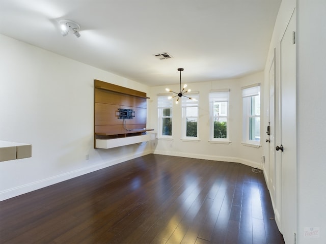 2104 Cullen Ave Unit 117, Austin, TX 78757 - unfurnished dining area featuring a chandelier, baseboards, and dark wood-style floors