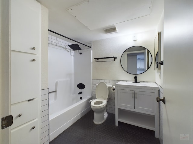 2104 Cullen Ave Unit 117, Austin, TX 78757 - bathroom featuring toilet, vanity, shower / bath combination, tile walls, and a wainscoted wall