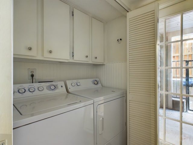 2104 Cullen Ave Unit 117, Austin, TX 78757 - laundry room featuring washing machine and clothes dryer, cabinet space, and healthy amount of natural light