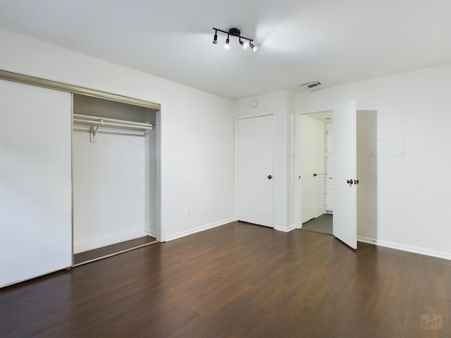 2104 Cullen Ave Unit 117, Austin, TX 78757 - unfurnished bedroom featuring wood finished floors, baseboards, and a closet
