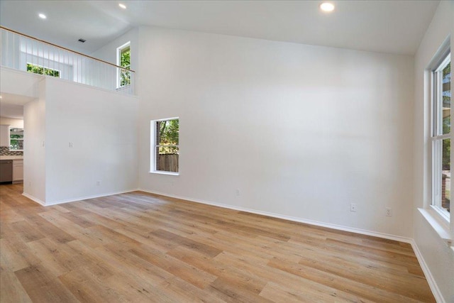 1025 Doras Dr, Pflugerville, TX 78660 - empty room with light wood-style flooring, recessed lighting, and a high ceiling